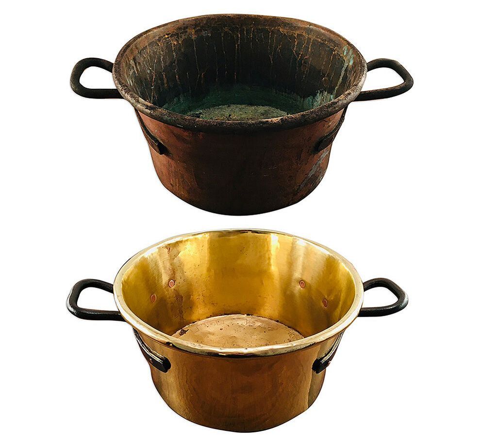 Antique brass bucket, revitalized to its former luster by expert metal polishing service, with gleaming steel handles.