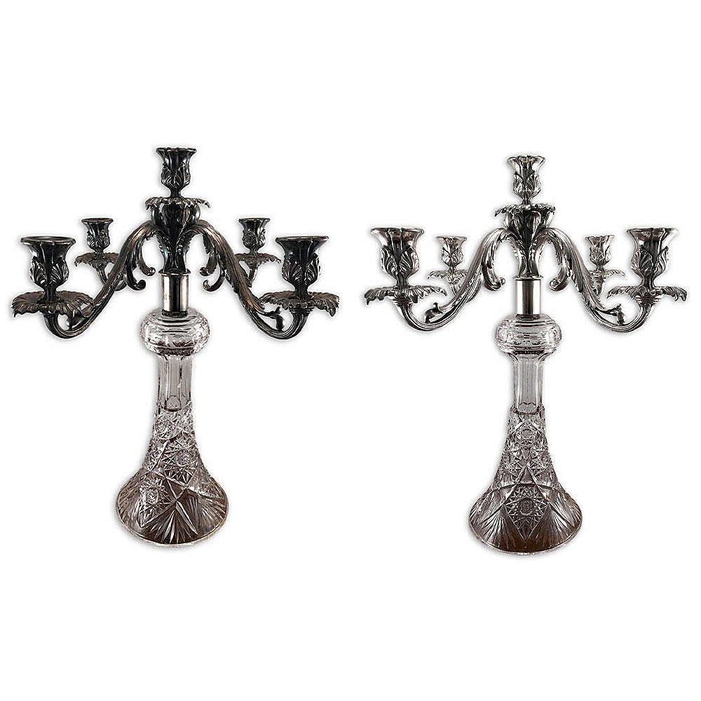Experience the resplendence of a professionally restored pair of antique silver plated candelabra featuring crystal bases, restored by Chelsea Plating Company. These timeless beauties embody the essence of vintage charm, meticulously transformed to their former grandeur. Trust the expertise of Philadelphia's esteemed restoration workshop since 1948, offering exceptional silver plating, polishing, and antique silver restoration services.