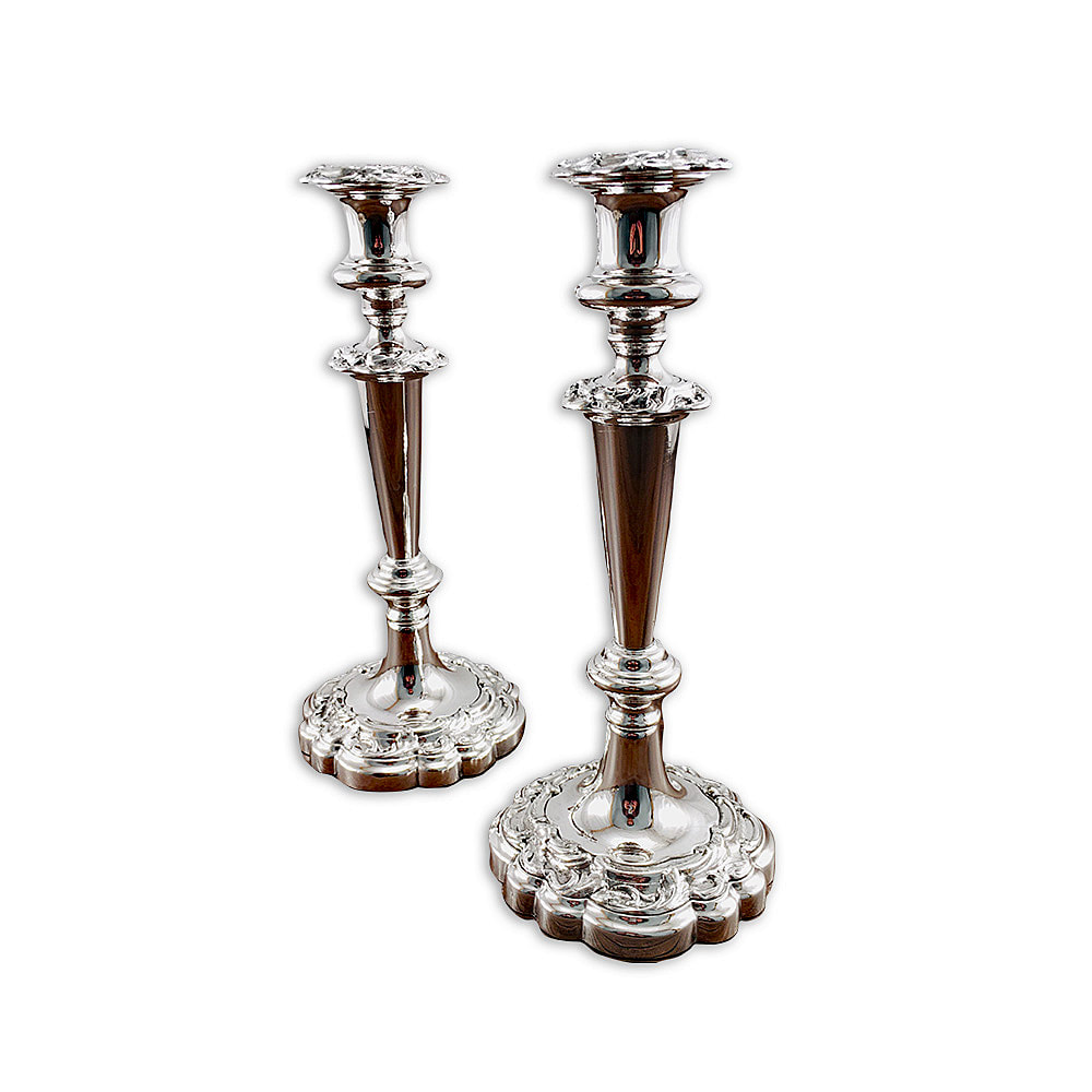 Unveil the splendor of this pair of antique sterling silver candlesticks, meticulously restored by Chelsea Plating Company. With their ornate design and impeccable craftsmanship, these candlesticks are a testament to the artistry of the past. Chelsea Plating Company's skilled craftsmen have breathed new life into these sterling silver treasures, meticulously repairing and polishing every intricate detail. The result is a dazzling display of elegance, where the candlesticks' pristine surfaces radiate with a renewed luster. Marvel at the beauty of these restored antique pieces, expertly brought back to their former glory by Chelsea Plating Company.