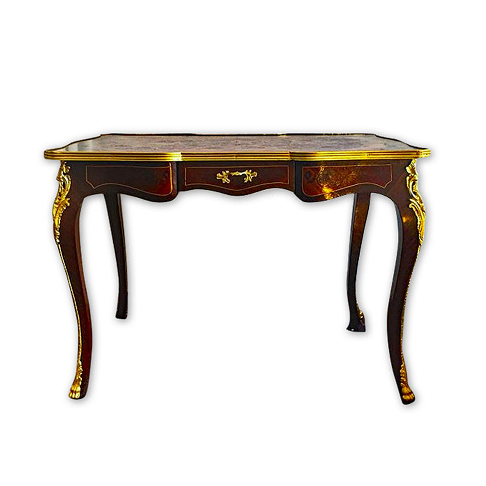 An antique French desk, meticulously restored by Chelsea Plating Company, with mounts adorned in gold leaf. The intricate woodwork and classic design have been rejuvenated, while the elegant gold leaf accents on the mounts highlight the desk's timeless allure. The careful restoration process exemplifies the mastery in antique restoration, fine woodworking, and gilding, ensuring the desk stands as a cherished piece of functional art, brimming with sophistication.