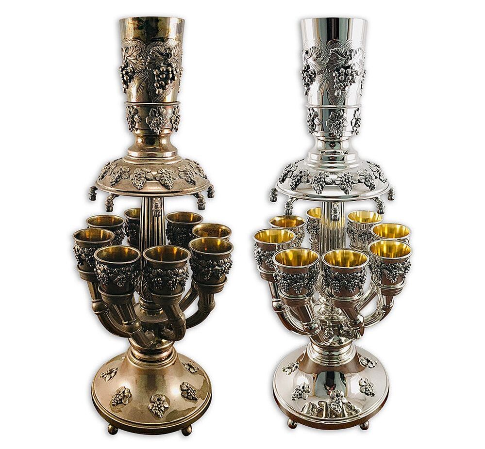 The sterling silver wine fountain showcased in this piece is an exquisite example of Judaica art, embodied with breathtaking beauty and cultural significance. In Jewish tradition, wine fountains like this one play a crucial role in sanctifying the Sabbath and other significant religious holidays during the Kiddush prayer. Although it required restoration, Chelsea Plating Company's highly skilled artisans restored it to its former glory through meticulous cleaning and polishing. Alongside that, they added a 24 karat gold wash to revamp the cups' insides carefully. Expertly preserved, the wine fountain's intricate details and designs showcase the unparalleled craftsmanship of its maker. Respected for their cultural significance, Judaica restoration requires both expertise and a deep understanding in this specialized field. With the combined efforts of restorers like Chelsea Plating Company, precious Judaica pieces such as this silver wine fountain can continue to be cherished by future generations for years to come; maintaining the Jewish people's rich cultural heritage.